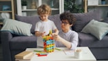 a woman and a child playing with a building set