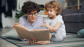 a man reading a book to a little girl