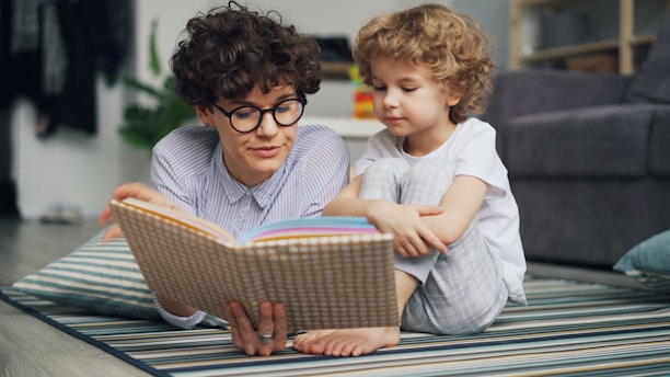 a man reading a book to a little girl