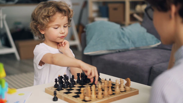 A little boy playing chess