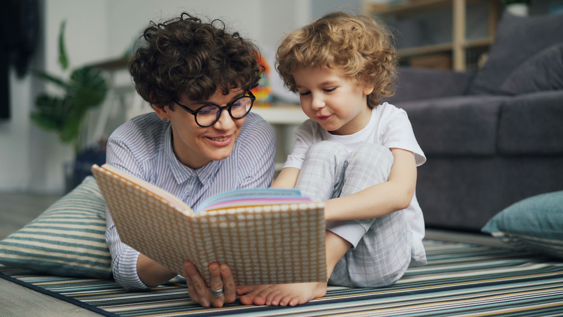 a man reading a book to a little girl