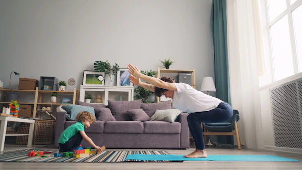 a woman and a child playing in a living room