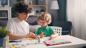 a man and a child are sitting at a table