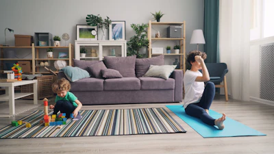 a woman sitting on a yoga mat with a child