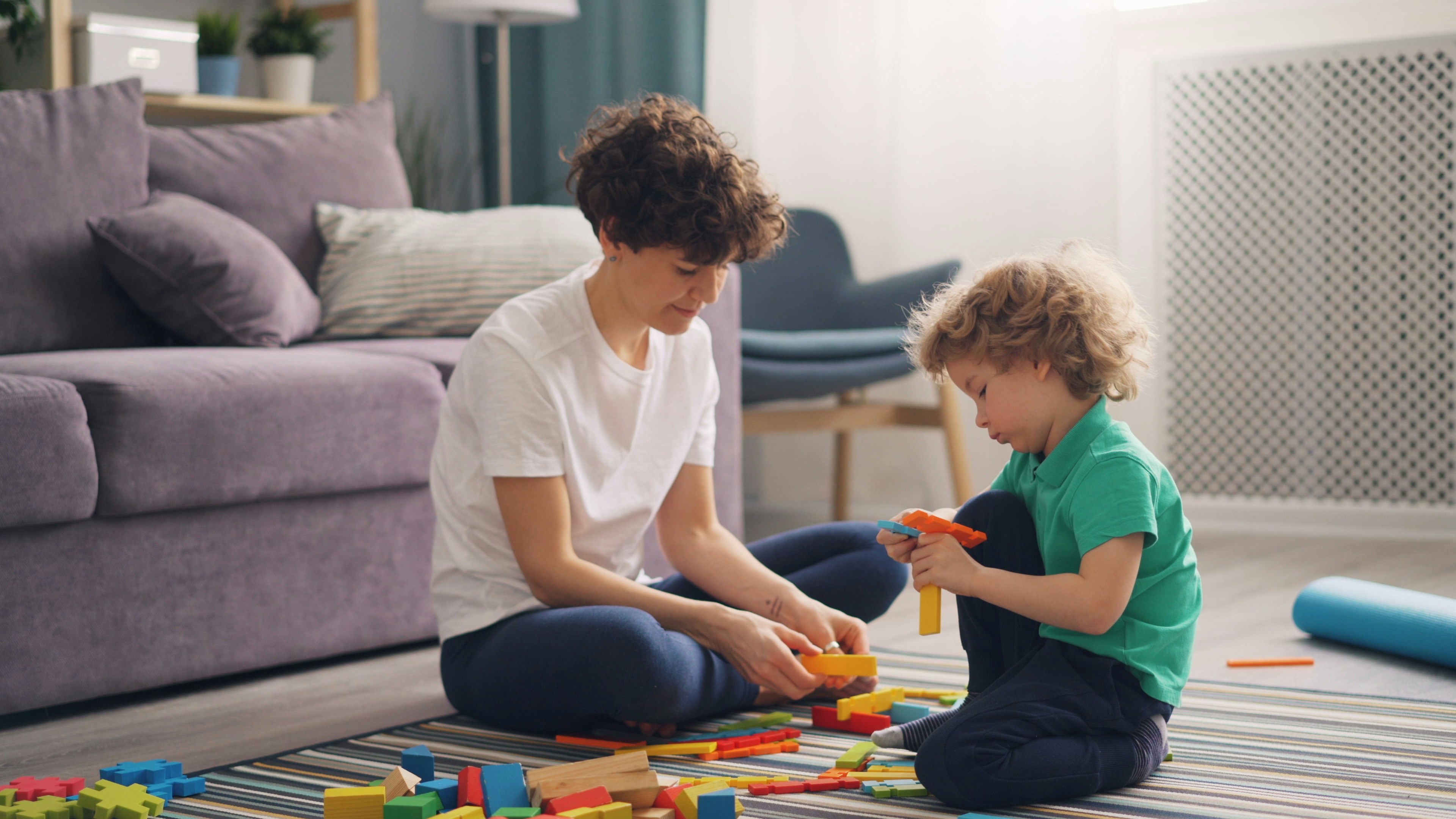 a therapist and child interacting with educational toys - aba therapy social skills
