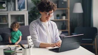 a woman sitting in front of a laptop computer