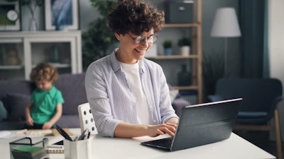 a woman sitting in front of a laptop computer