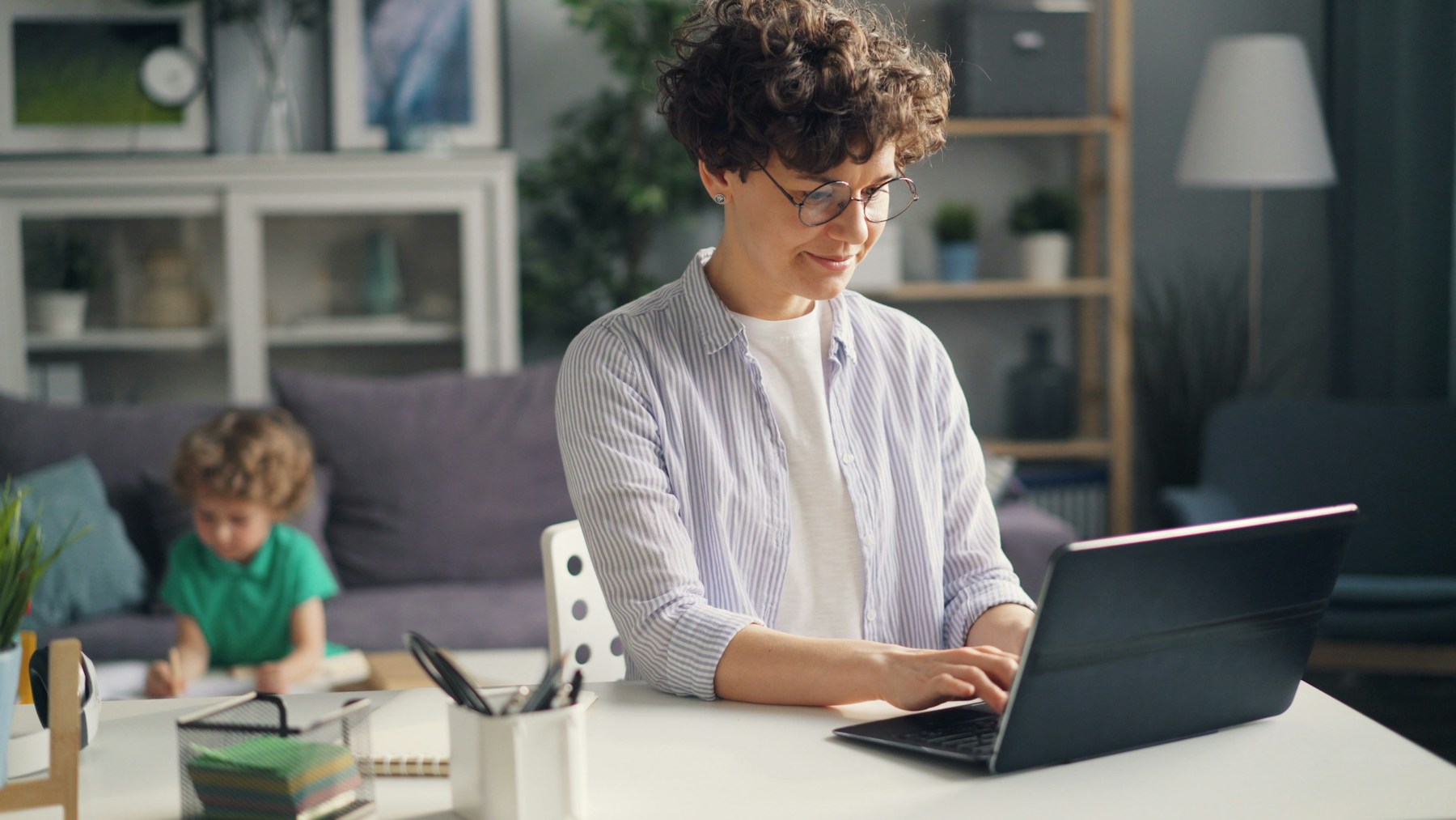 A woman working on a laptop computer at a table