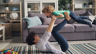 a woman is holding a child in the air