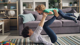a woman is holding a child in the air