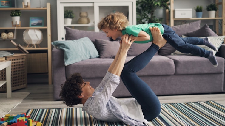 a woman is holding a child in the air