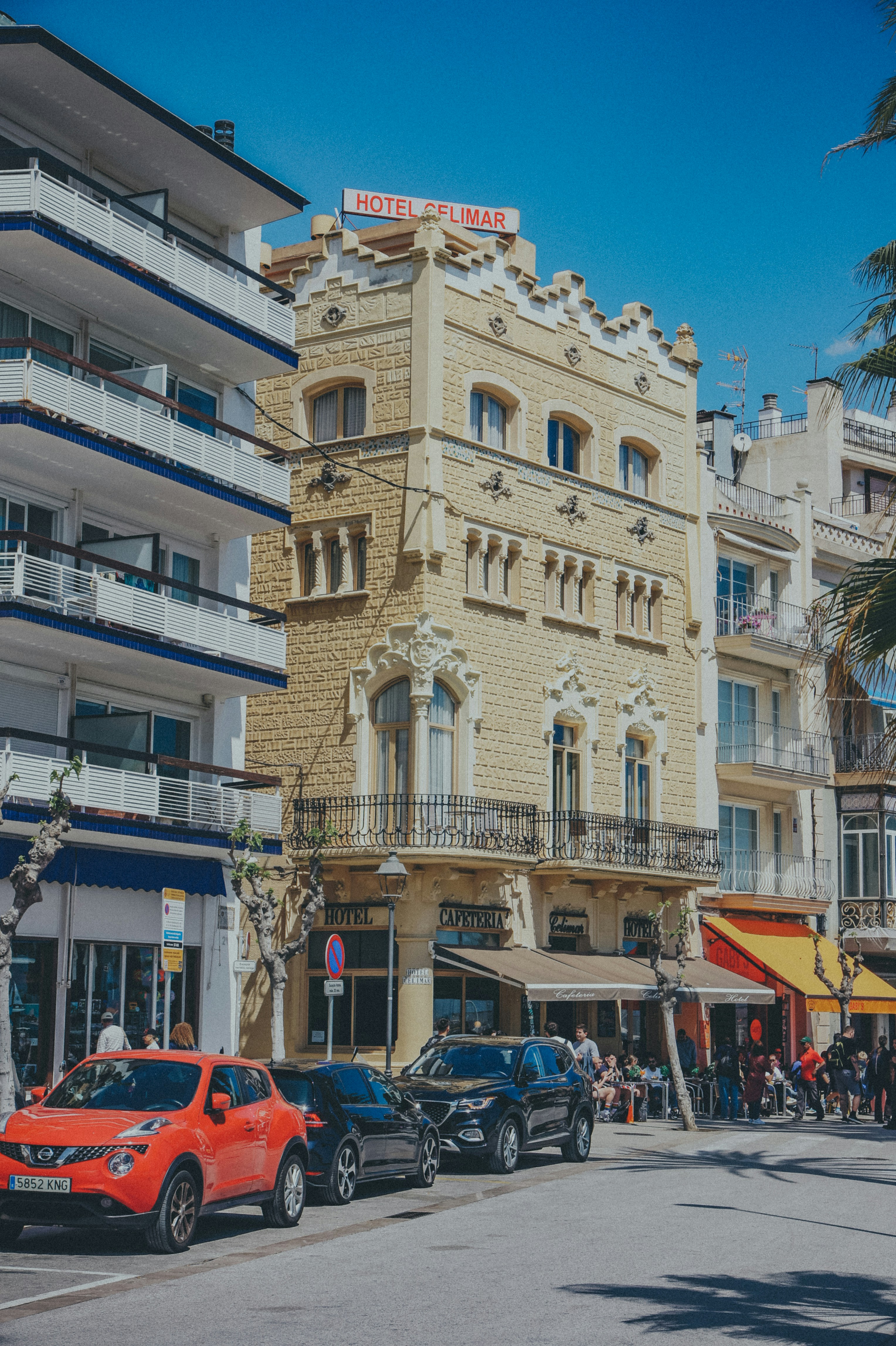 cars parked on the side of the road in front of a building