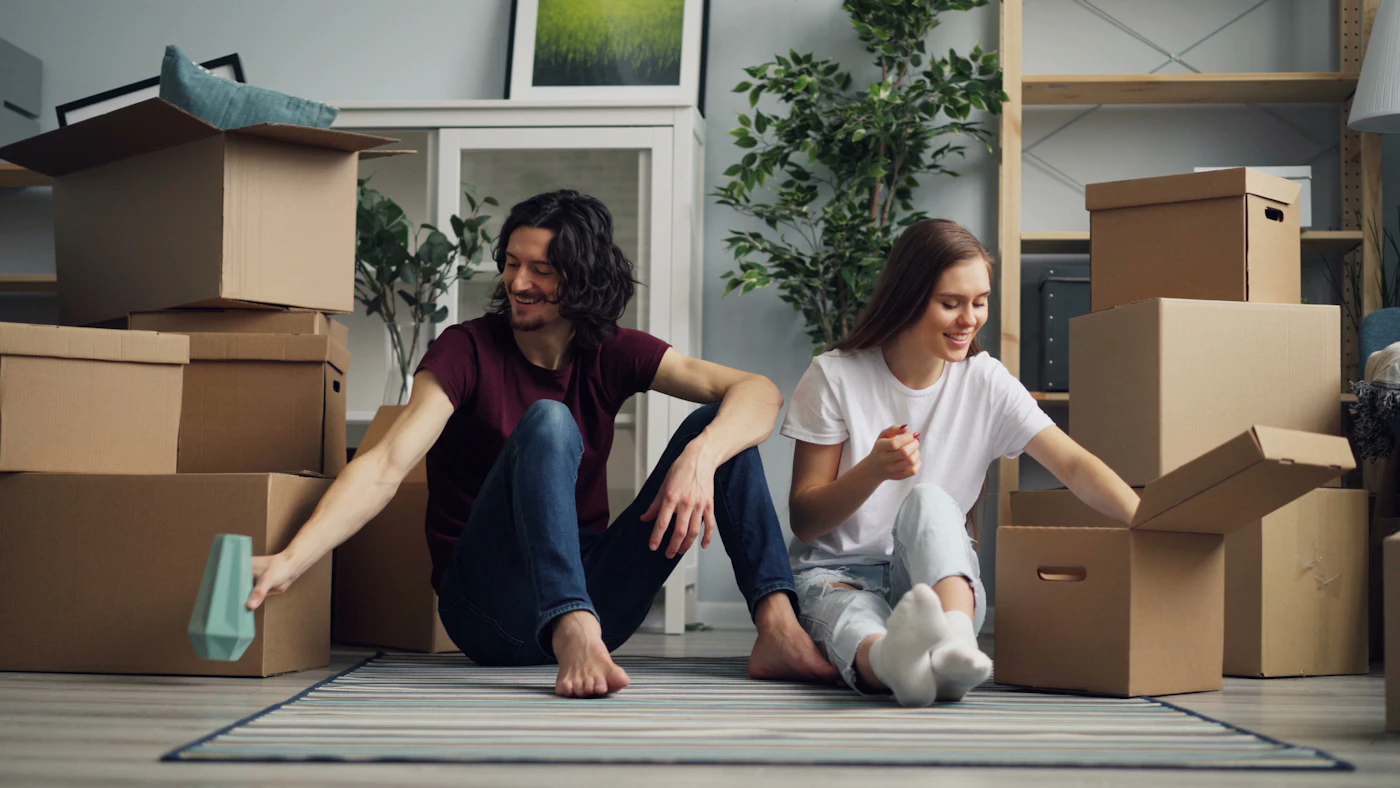 Two women unpacking moving boxes in a new home