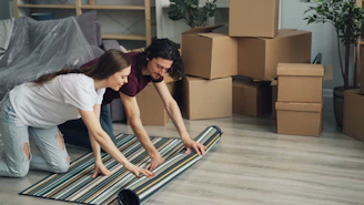 a man and a woman laying on a rug