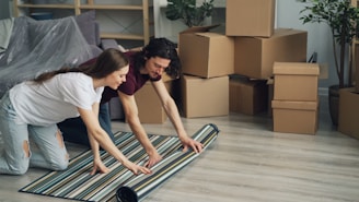 a man and a woman laying on a rug