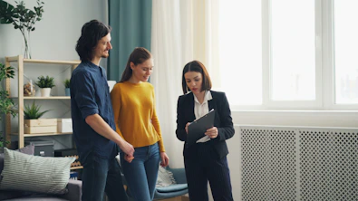 a group of people standing around a living room