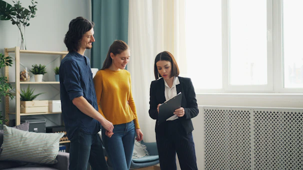 a group of people standing around a living room