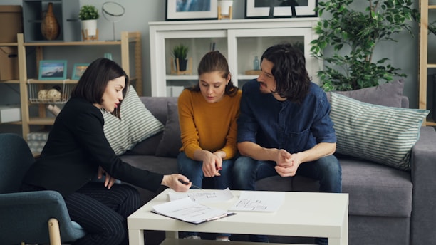 three women sitting on a couch talking to each other
