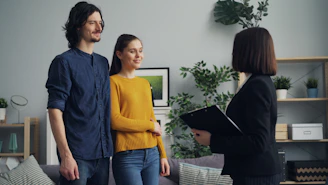 a man and a woman standing in a living room