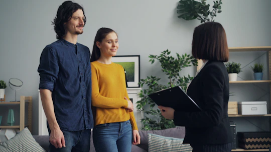 a man and a woman standing in a living room