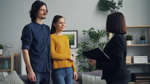 a man and a woman standing in a living room