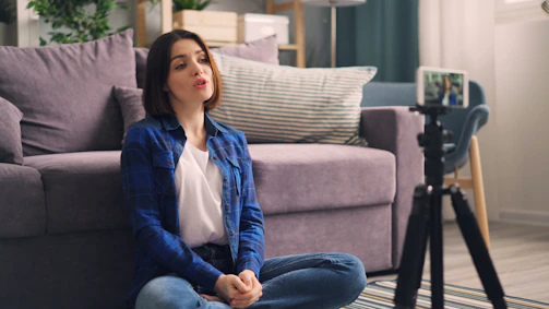 a woman sitting on the floor in front of a couch