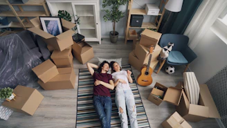 a couple of people laying on a rug in a room