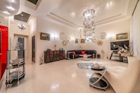 a living room filled with furniture and a chandelier