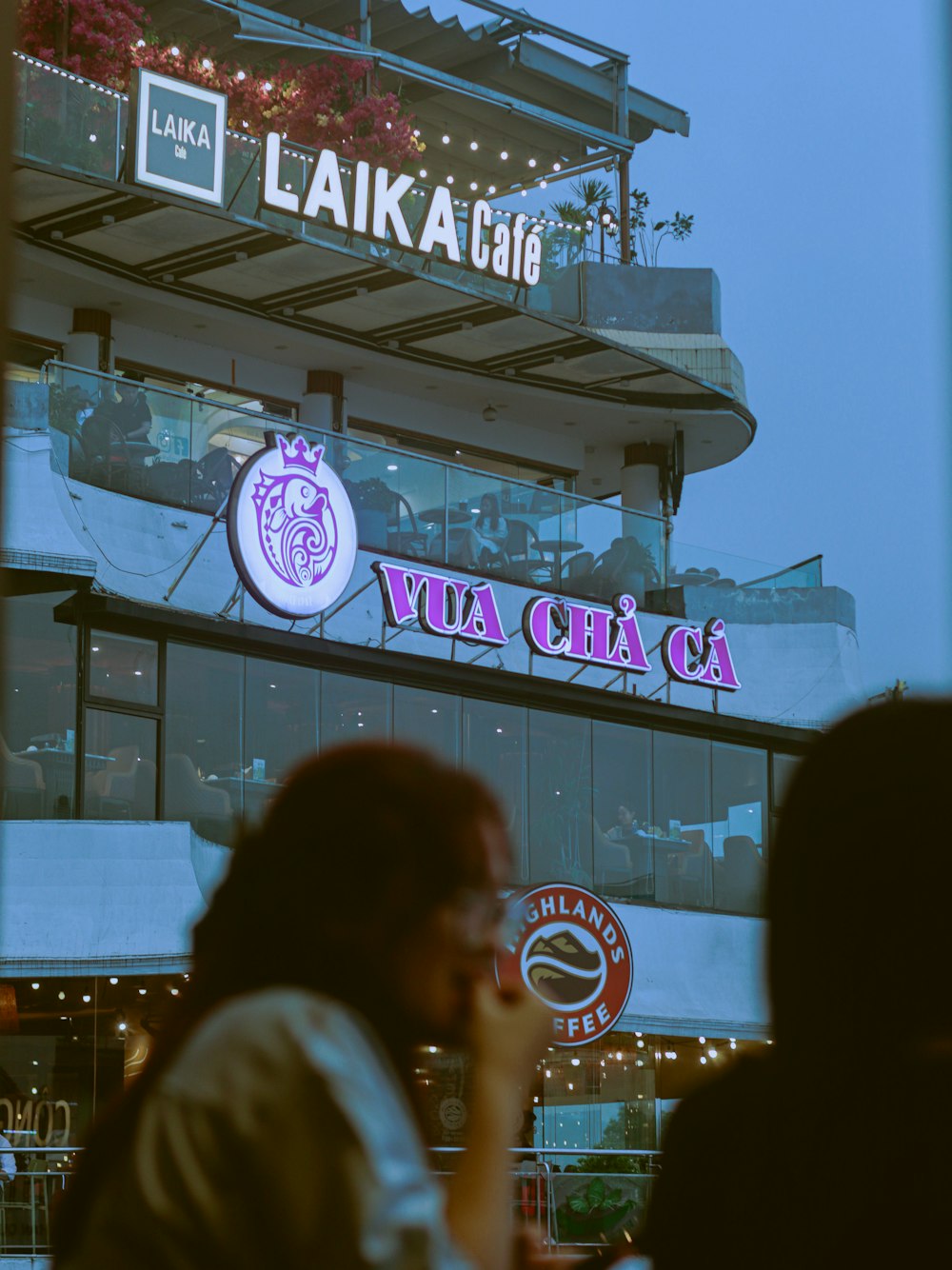 a man talking on a cell phone in front of a building