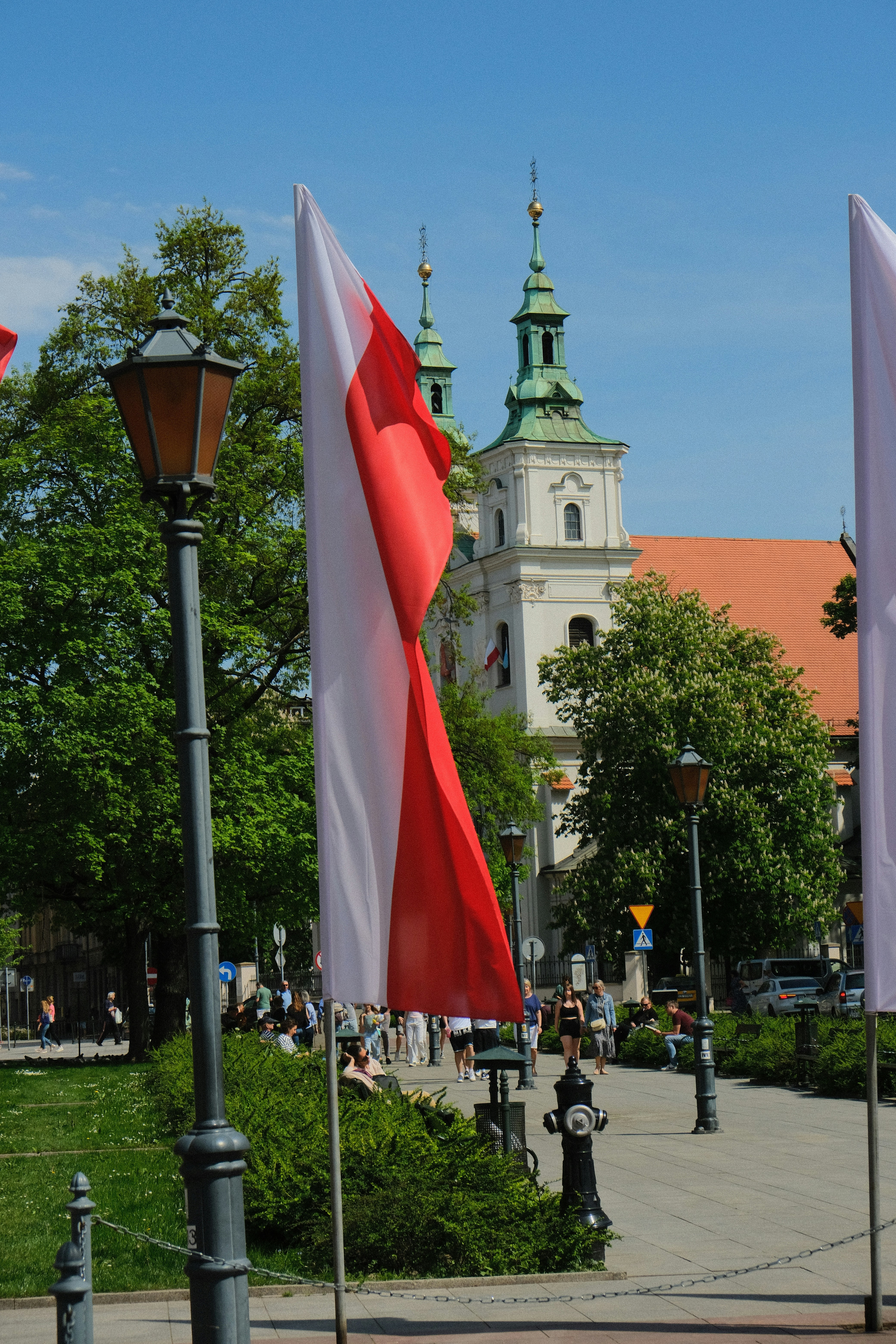 a group of flags that are next to a street light