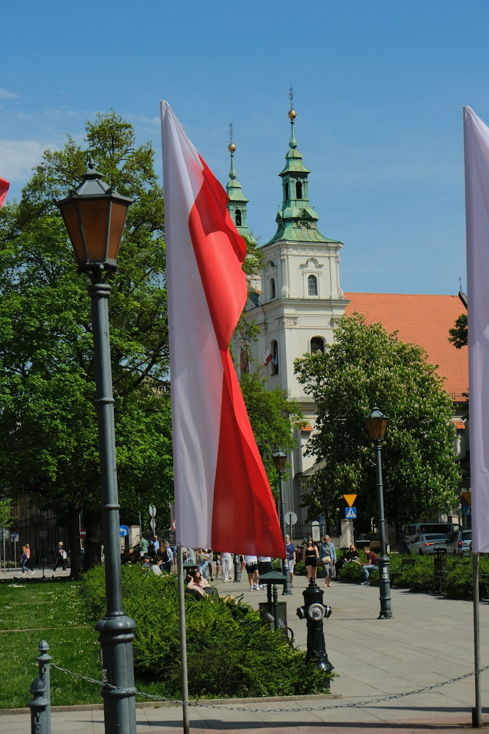 a group of flags that are next to a street light