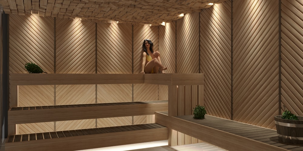 a woman sitting in a sauna in a wooden sauna