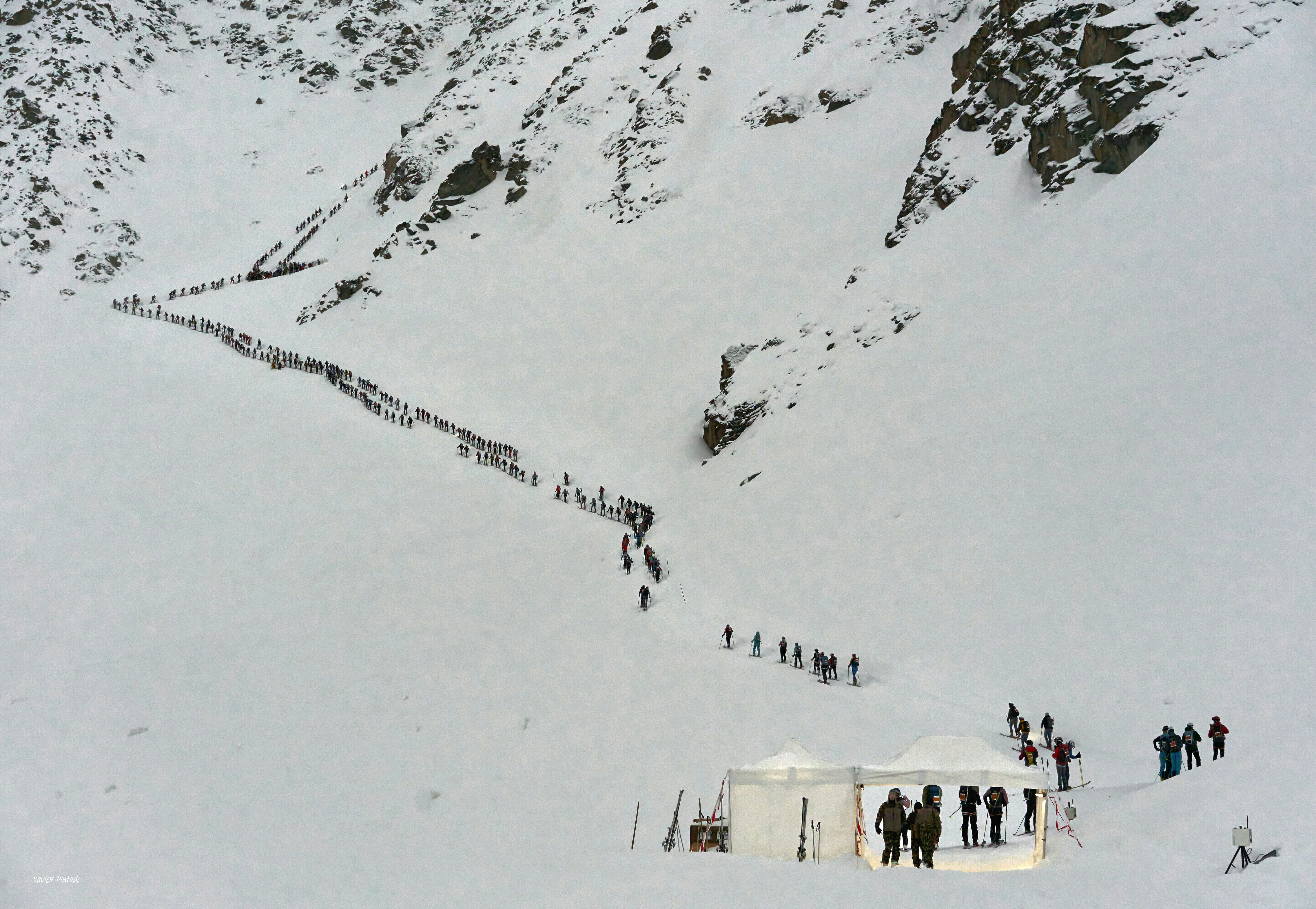 a group of people standing on top of a snow covered slope