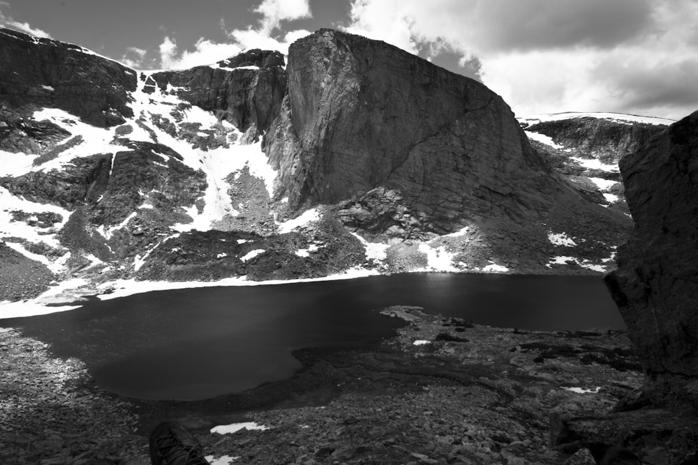 a black and white photo of a mountain lake