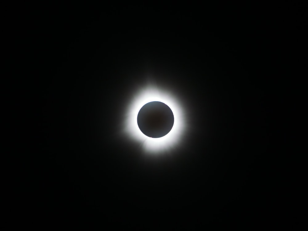 a solar eclipse is seen in the dark sky