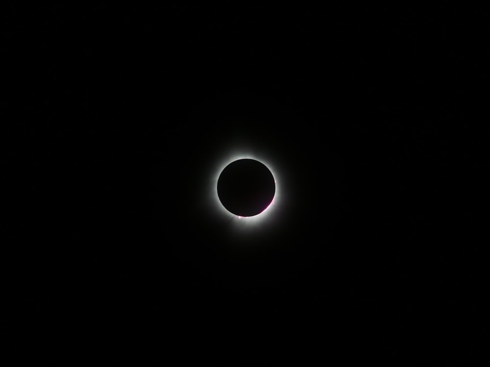 a solar eclipse is seen in the dark sky