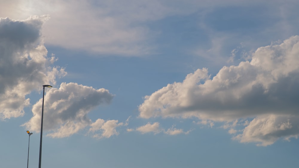 a street light with a lot of clouds in the background