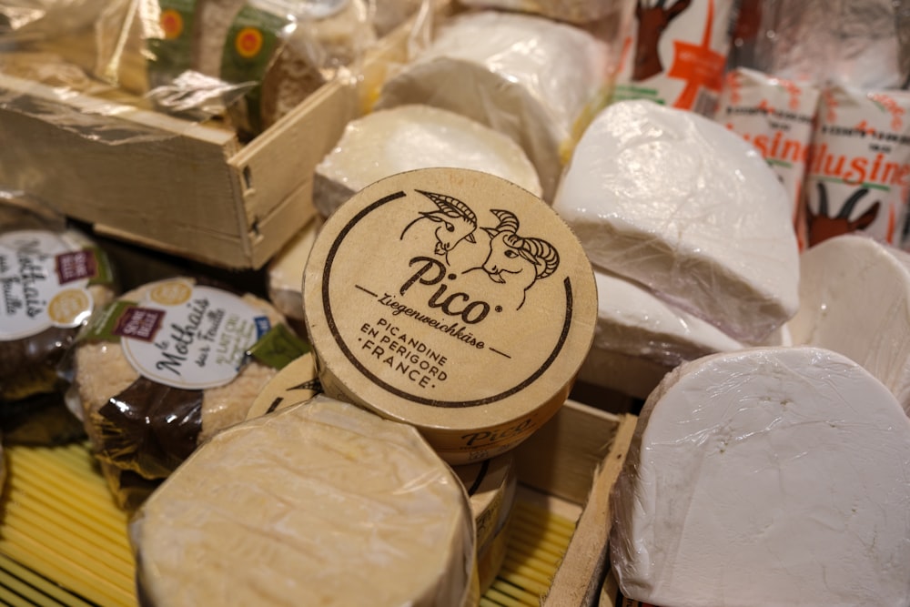 a variety of cheeses on display in a store
