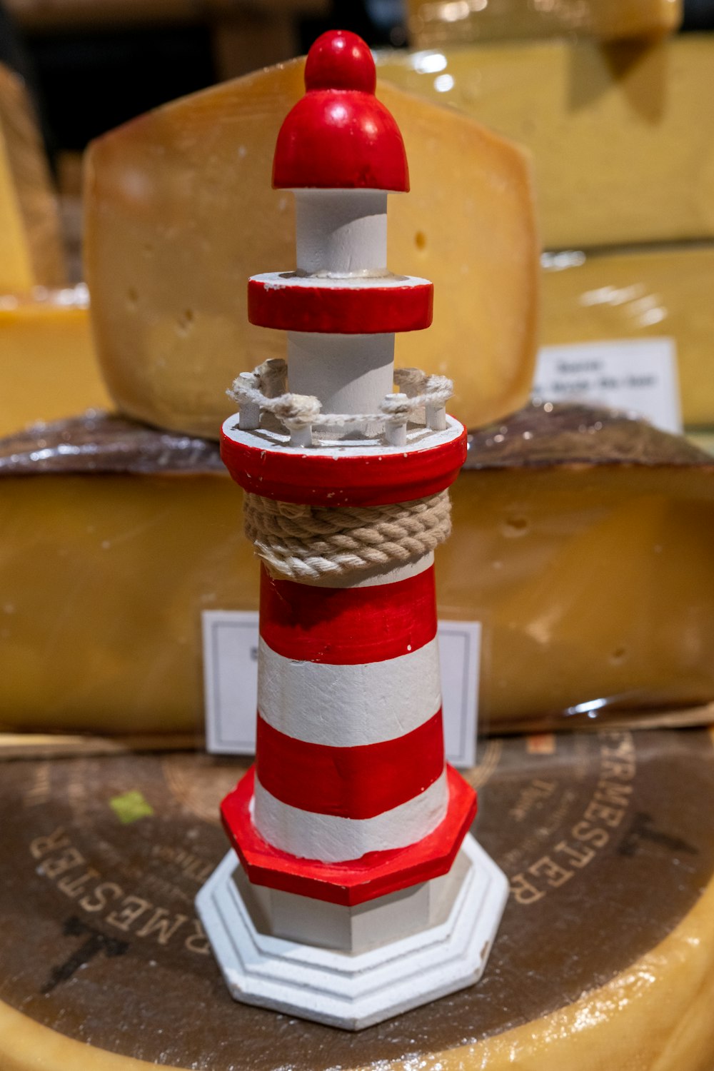a red and white lighthouse on a wooden table