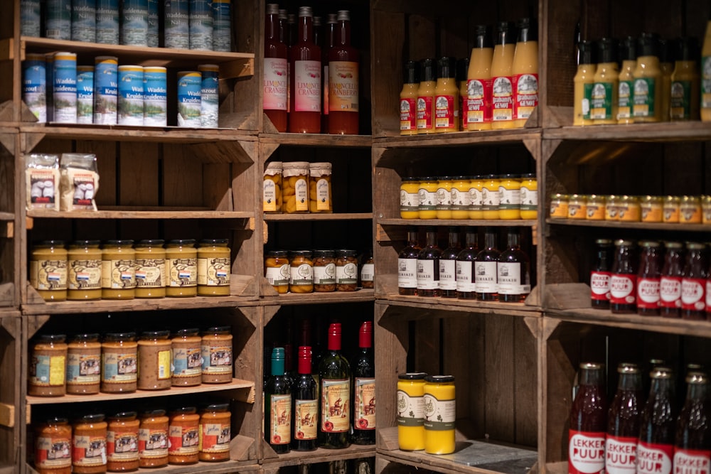 a wooden shelf filled with lots of bottles of liquid