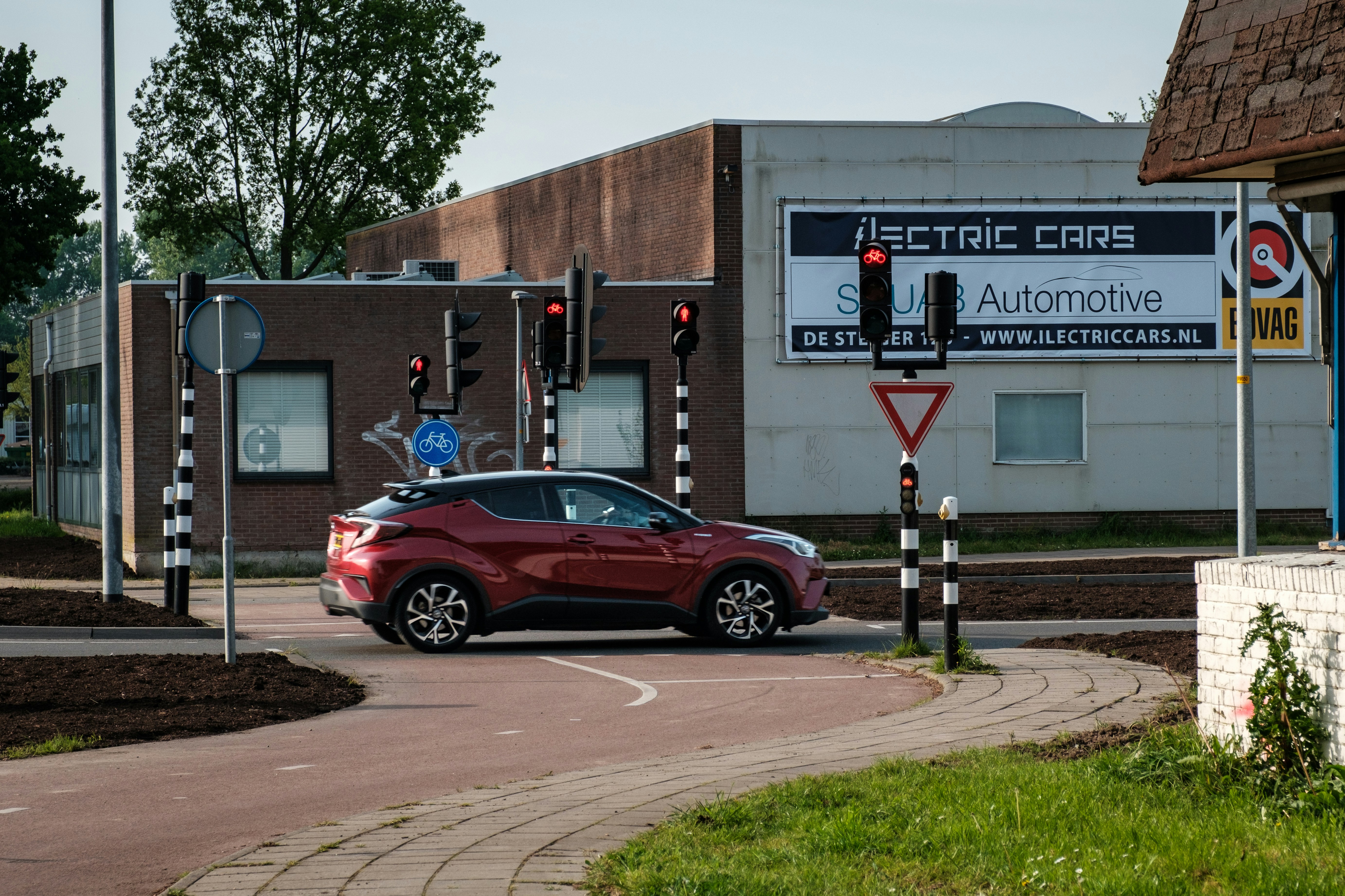 Used electric vehicles lined up at a modern dealership lot