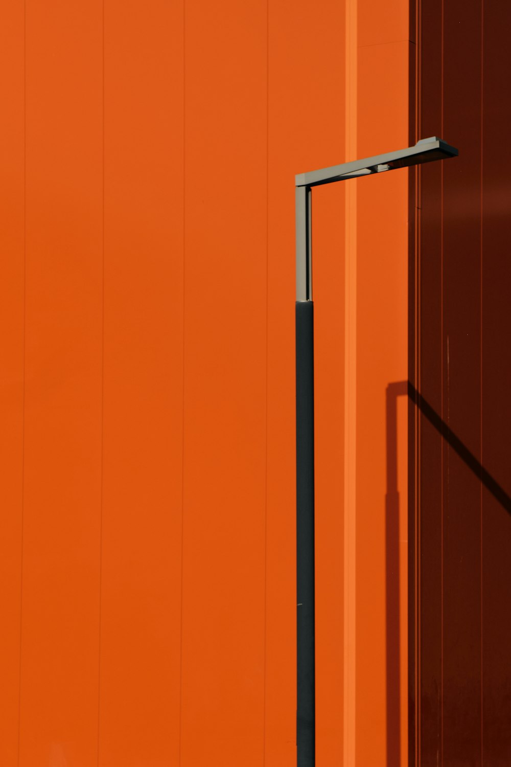 an orange building with a street light next to it