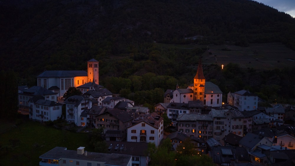 a small town lit up at night in the mountains