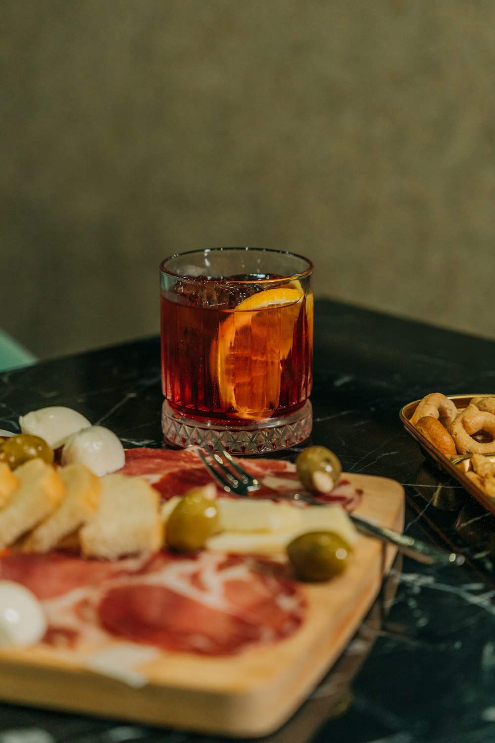 a glass of wine and some food on a table