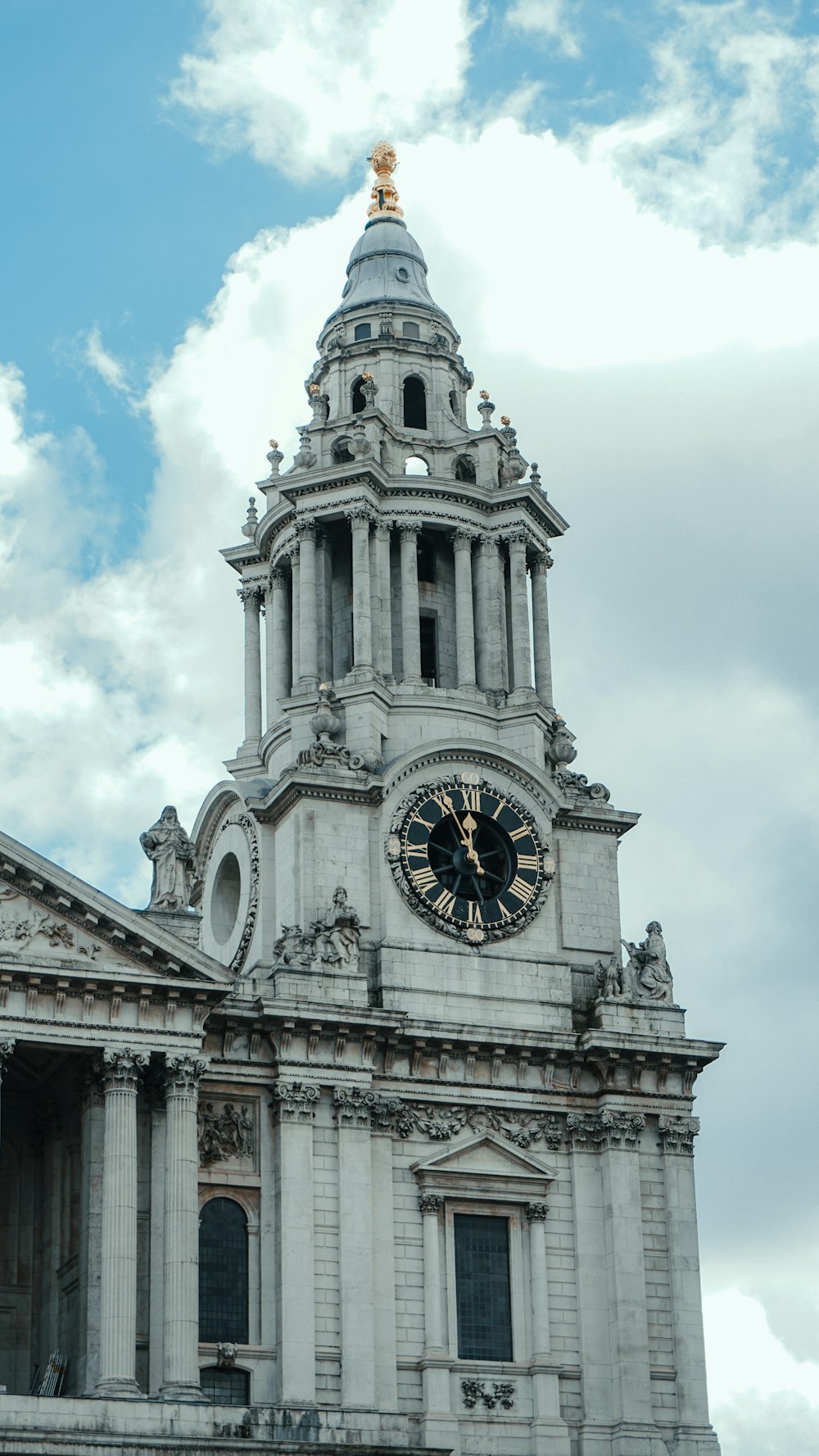 a large clock tower with a sky background