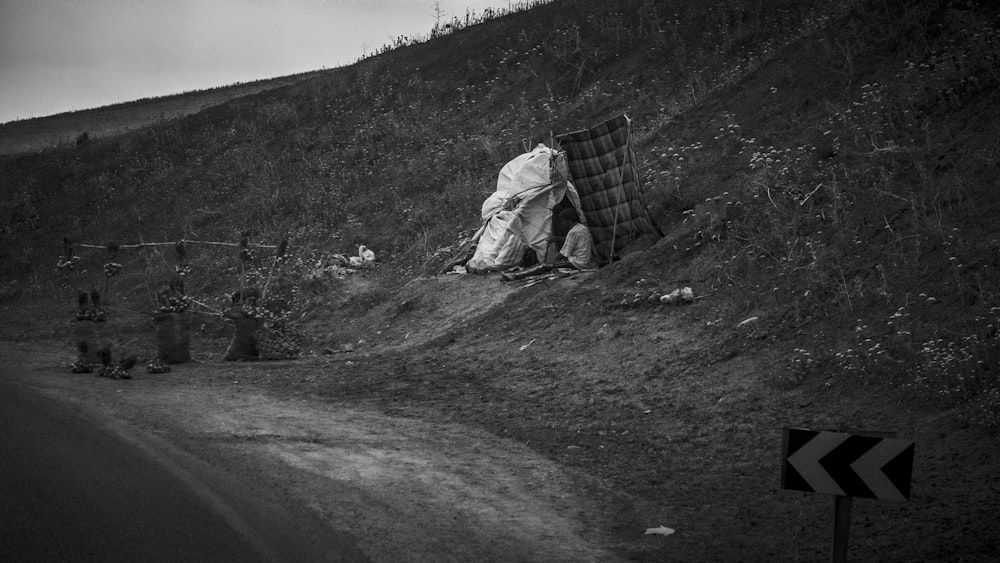 a black and white photo of a tarp on the side of a road