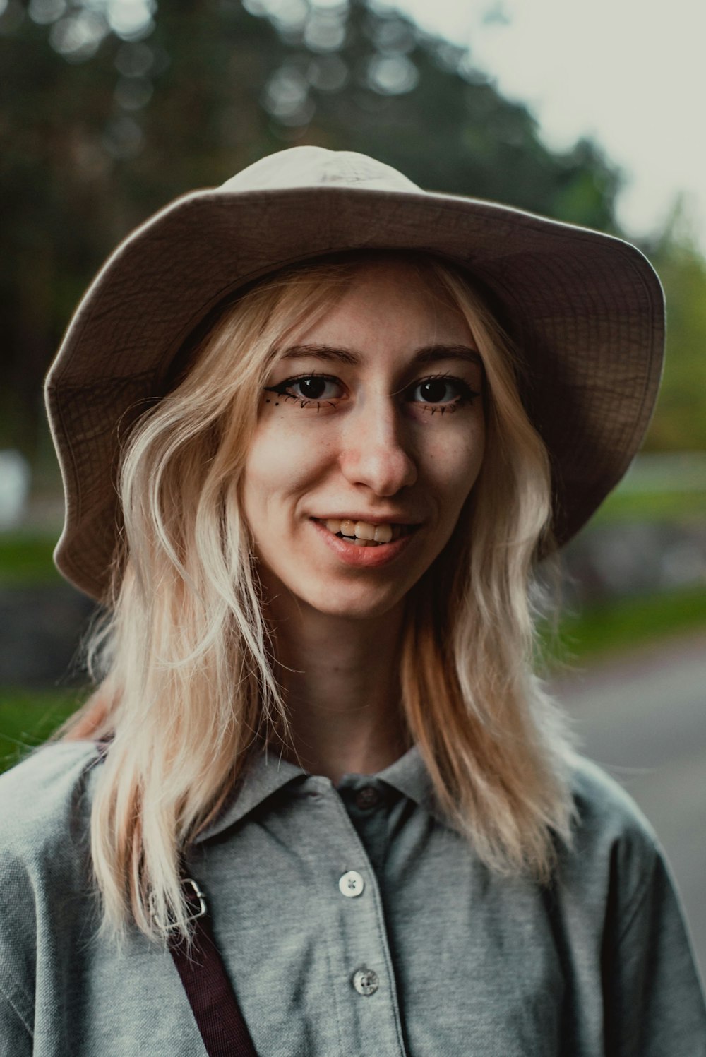 a woman wearing a hat and a gray shirt