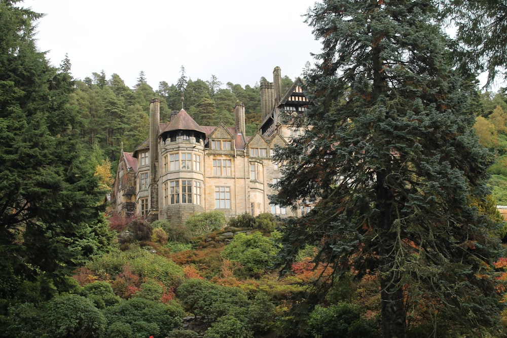 a large building sitting on top of a lush green hillside