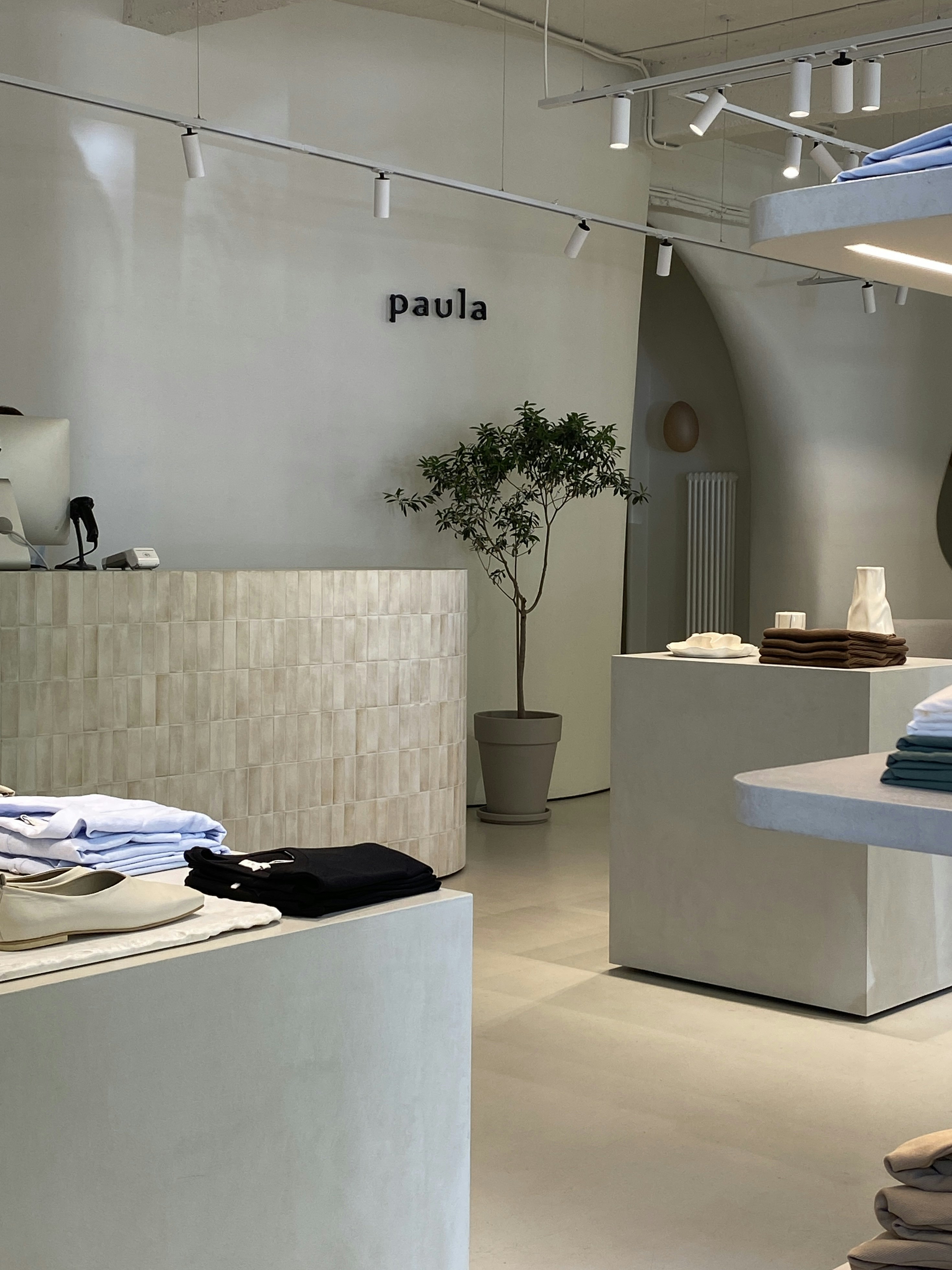 Casual fashion store interior with folded clothing on shelves