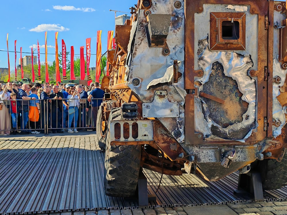 a group of people standing around a large truck